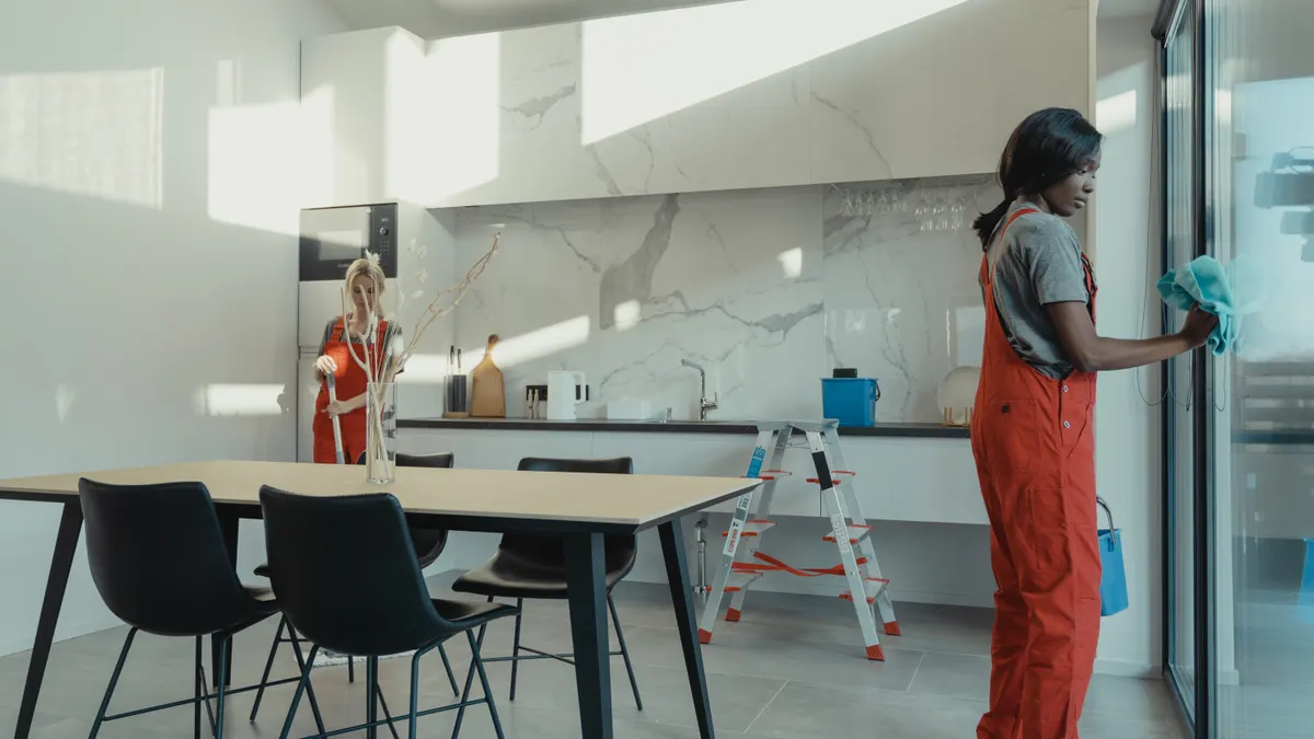 Affordable house cleaning services: whatās included in a standard visit Two cleaners working in a modern kitchen