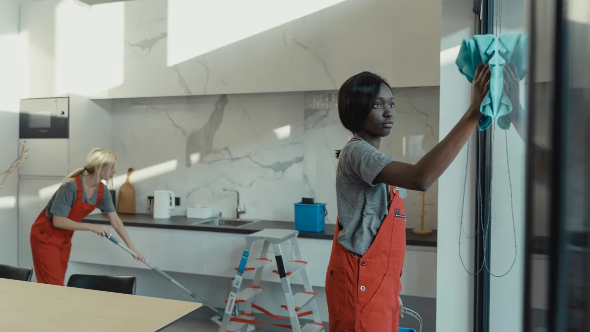 Affordable house cleaning services: whatās included in a standard visit Cleaners wiping a kitchen and glass door