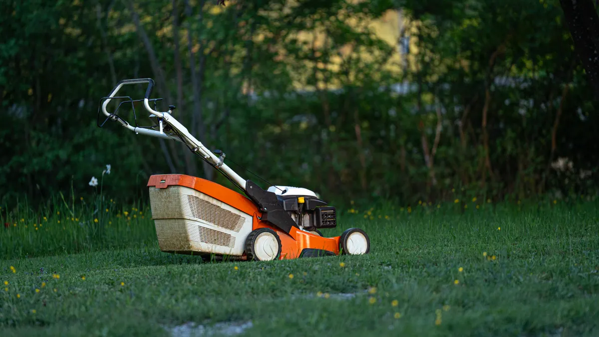 Budget lawn care services for homeowners: what to ask before booking Push lawn mower on a green lawn