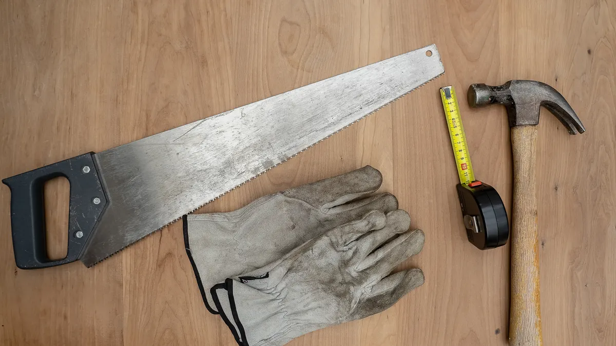 Cheap handyman services near me: what to expect and how to compare Hand saw, hammer, tape measure, and gloves on wood